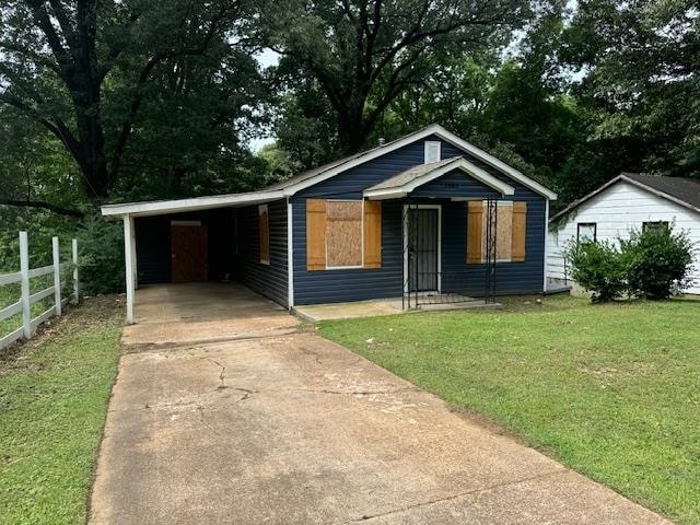 bungalow-style house featuring a front lawn and a carport