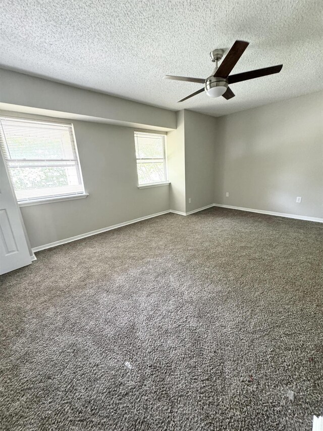 carpeted empty room with a textured ceiling and ceiling fan