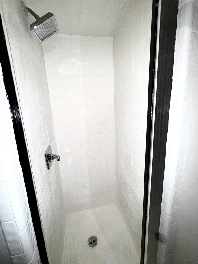 bathroom with tiled shower