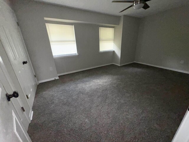 carpeted spare room with ceiling fan