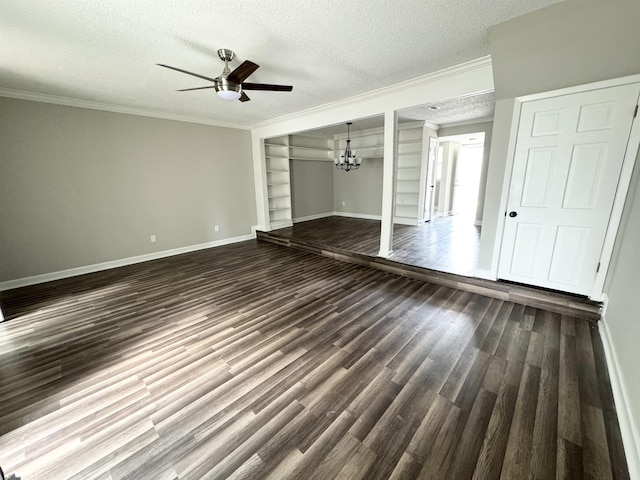 unfurnished living room featuring dark hardwood / wood-style flooring, ceiling fan with notable chandelier, a textured ceiling, crown molding, and built in features