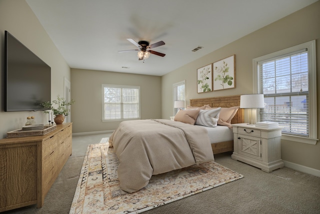 bedroom featuring ceiling fan and light carpet