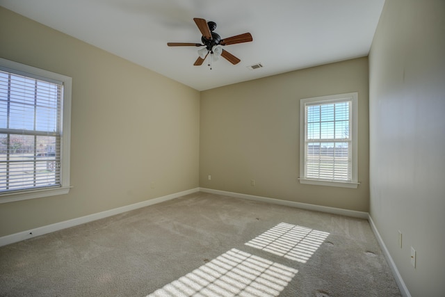 unfurnished room featuring ceiling fan and light colored carpet