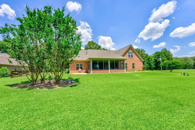 rear view of house with a yard