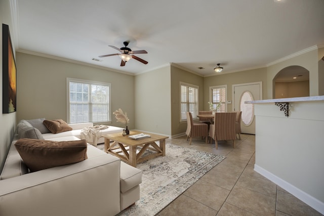 tiled living room featuring ceiling fan and ornamental molding