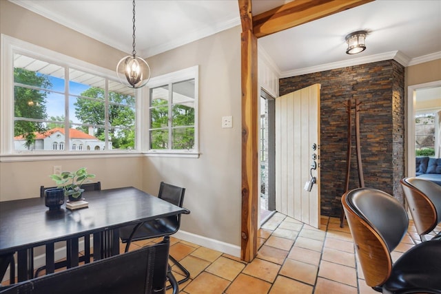 tiled dining space with ornamental molding, a wealth of natural light, and a chandelier