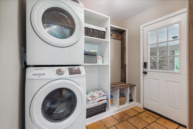 laundry room with stacked washer and clothes dryer and light tile floors