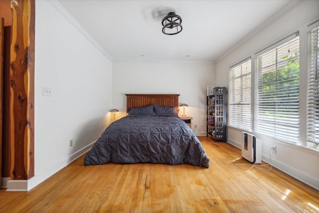 bedroom featuring light hardwood / wood-style floors and ornamental molding