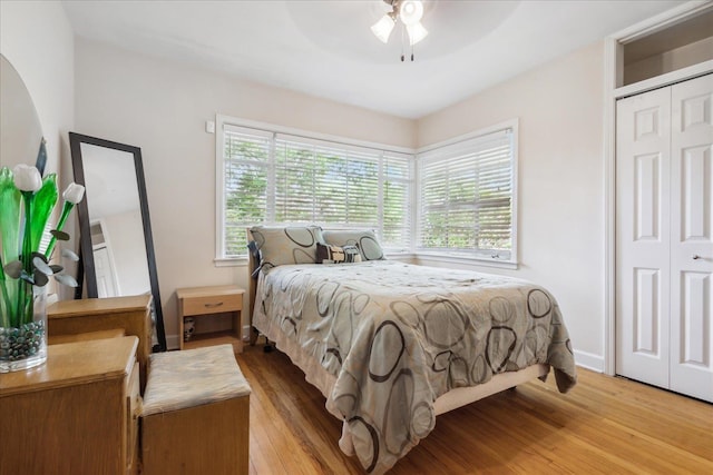 bedroom with ceiling fan, a closet, and hardwood / wood-style flooring