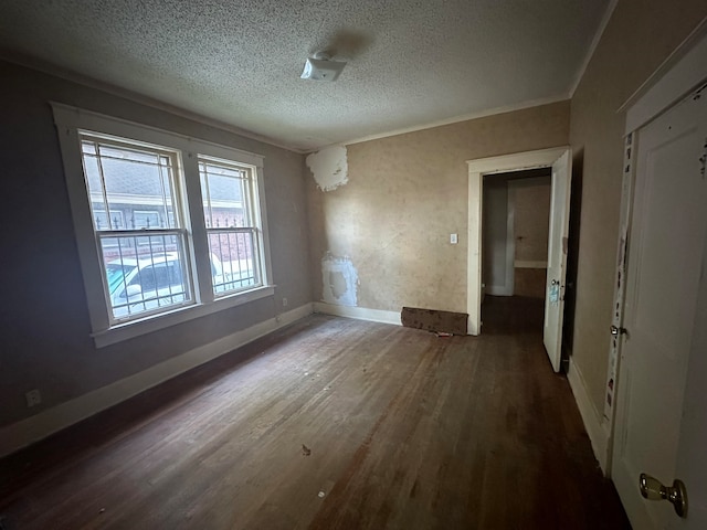 unfurnished bedroom featuring crown molding, a textured ceiling, and dark hardwood / wood-style flooring