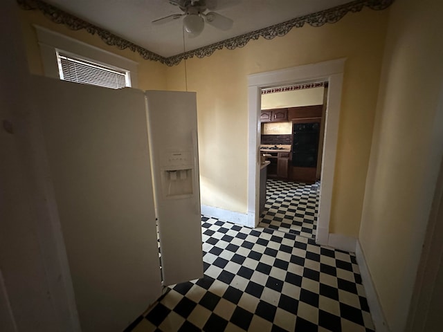 hall with dark tile flooring