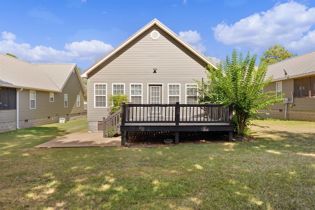 back of house featuring a lawn, a patio, and a deck