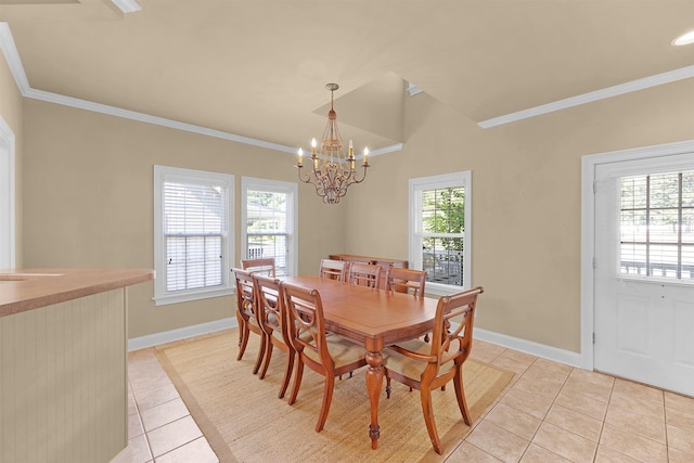 dining area with ornamental molding, vaulted ceiling, light tile patterned floors, and an inviting chandelier