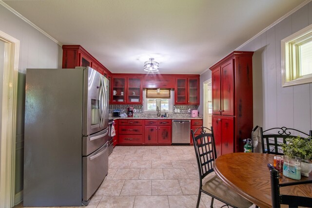 kitchen with backsplash, stainless steel appliances, ornamental molding, and sink