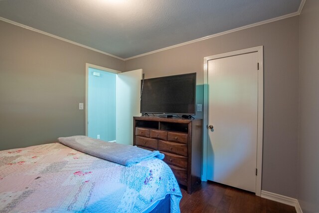 bedroom with crown molding and dark wood-type flooring