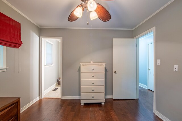 unfurnished bedroom with ceiling fan, crown molding, dark wood-type flooring, and ensuite bath