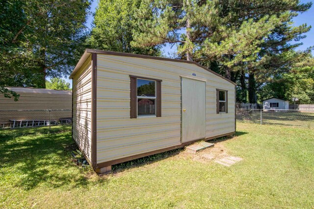 view of outbuilding with a lawn