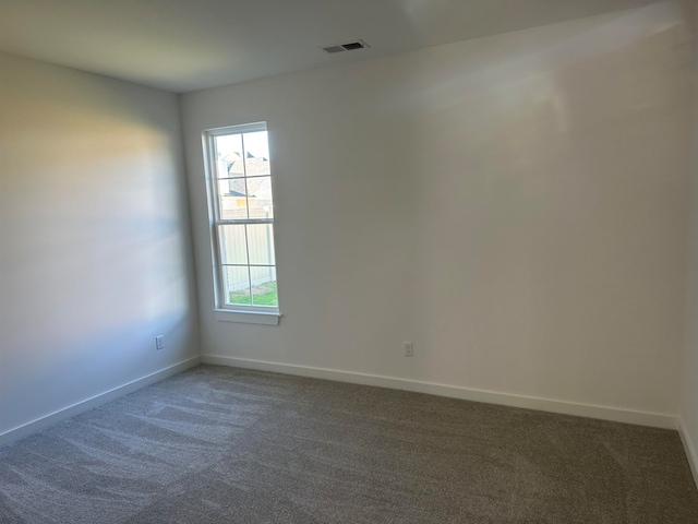 empty room featuring dark carpet