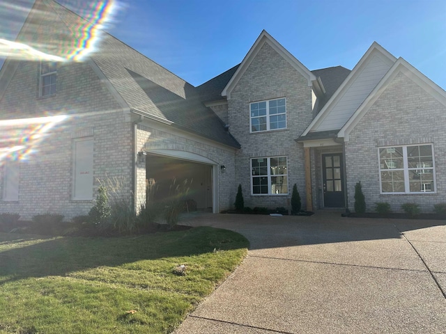 view of front of property with a garage and a front lawn