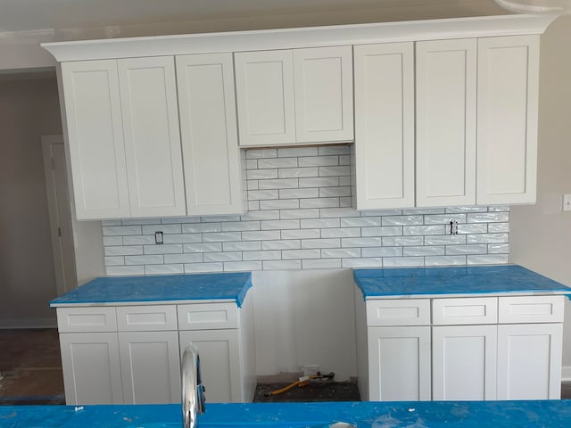 kitchen featuring white cabinets and tasteful backsplash