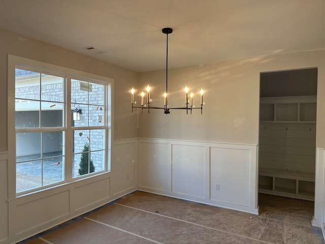 unfurnished dining area featuring a wealth of natural light and an inviting chandelier