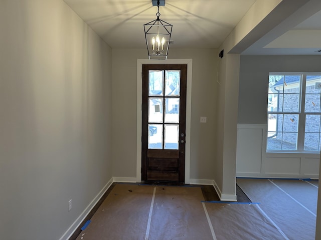 entryway featuring a healthy amount of sunlight and a notable chandelier