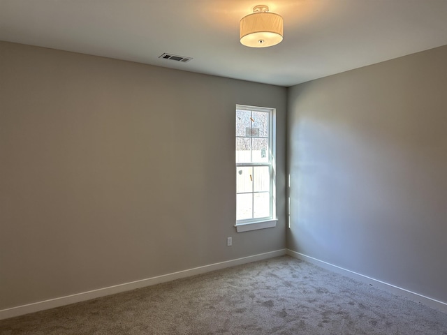 carpeted spare room featuring a healthy amount of sunlight