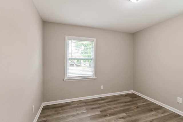 empty room with baseboards and wood finished floors