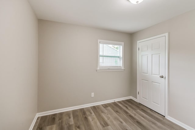 unfurnished bedroom with baseboards and light wood-style flooring