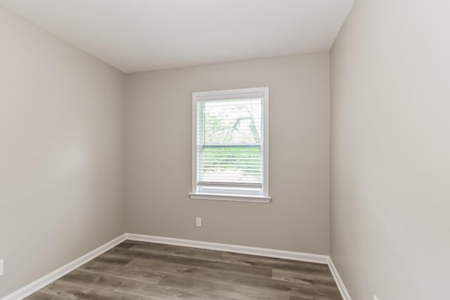 unfurnished room featuring baseboards and wood finished floors