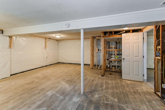 unfinished below grade area with wood finished floors and visible vents