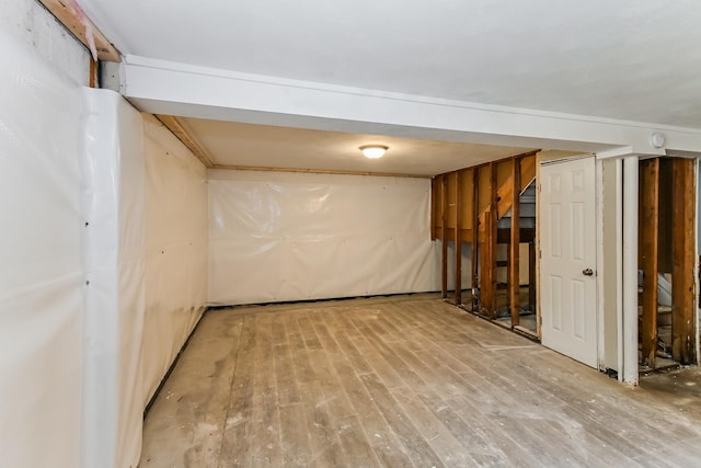 finished basement with stairs and wood finished floors