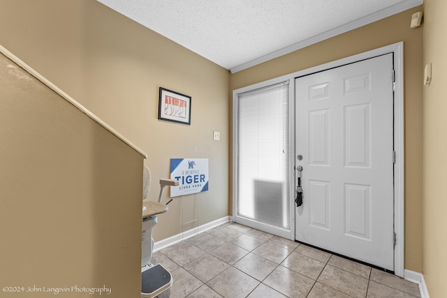 foyer featuring a textured ceiling and light tile patterned floors