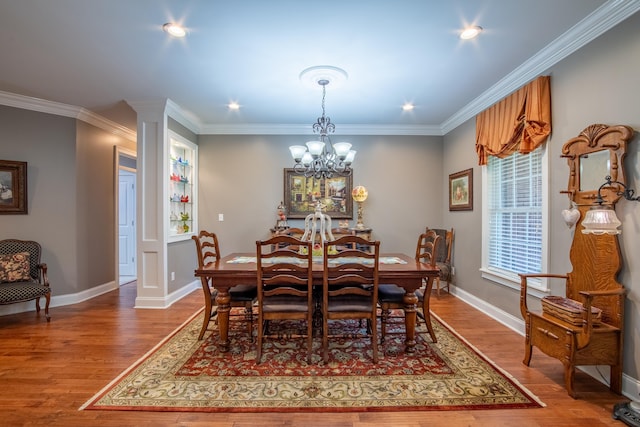 dining room with crown molding, a chandelier, and wood-type flooring