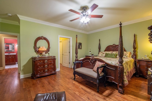 bedroom featuring ceiling fan, crown molding, ensuite bathroom, and wood-type flooring