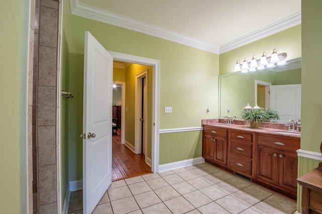 bathroom with tile patterned floors, vanity, and ornamental molding