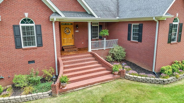 view of exterior entry featuring covered porch