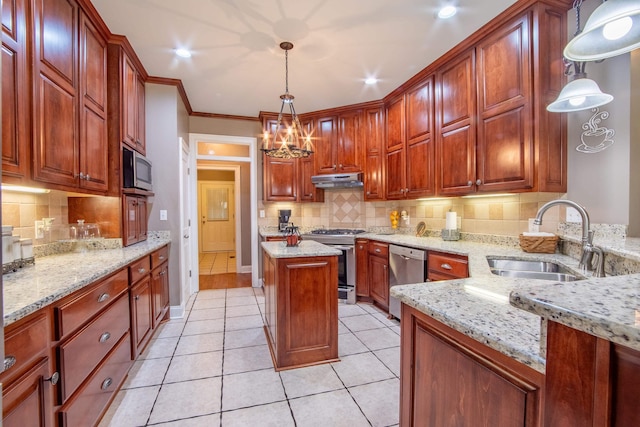 kitchen with stainless steel appliances, light stone counters, sink, and pendant lighting