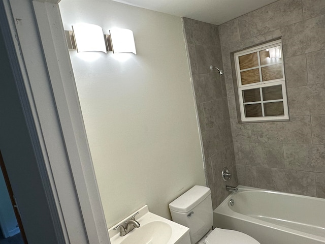 full bathroom with sink, toilet, and tiled shower / bath combo