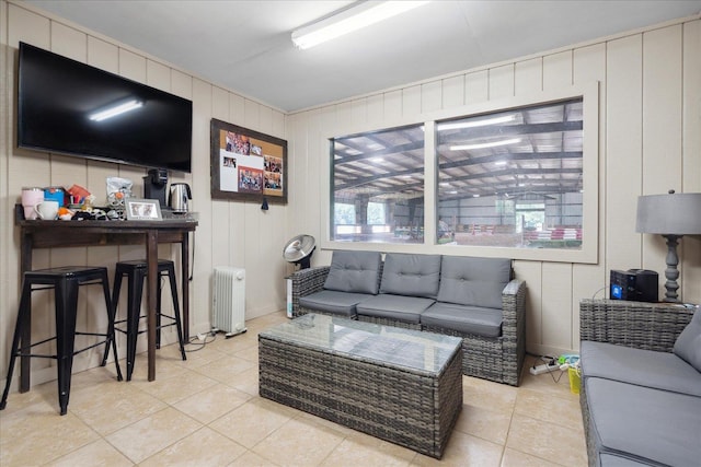 tiled living room featuring radiator