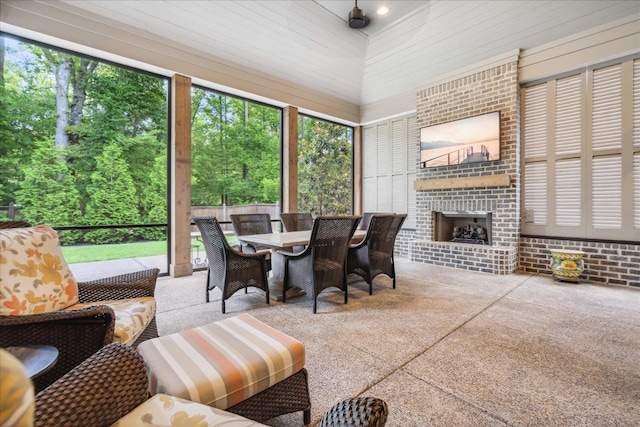 sunroom / solarium featuring an outdoor brick fireplace