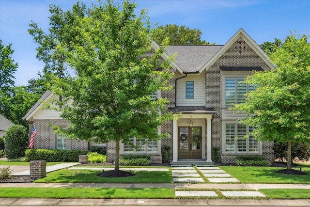 view of front of house with a front lawn and french doors