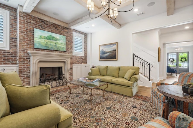 living room with beam ceiling, wood-type flooring, brick wall, and a chandelier