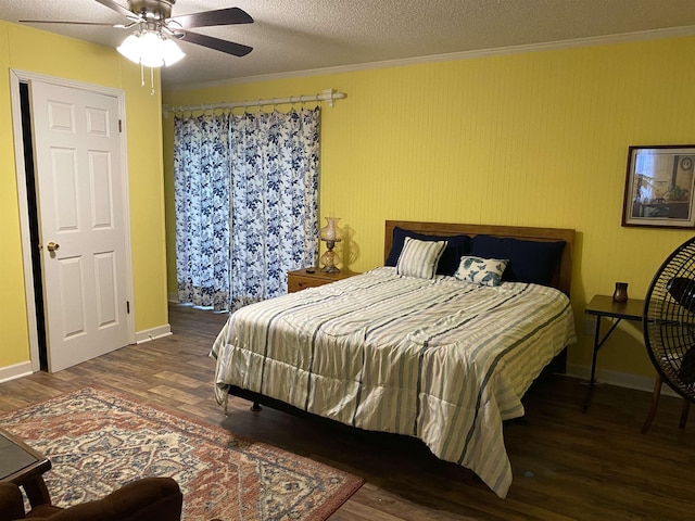 bedroom featuring dark hardwood / wood-style flooring, ceiling fan, crown molding, and a textured ceiling