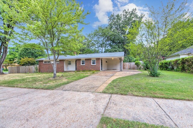 ranch-style house with a front lawn and a carport