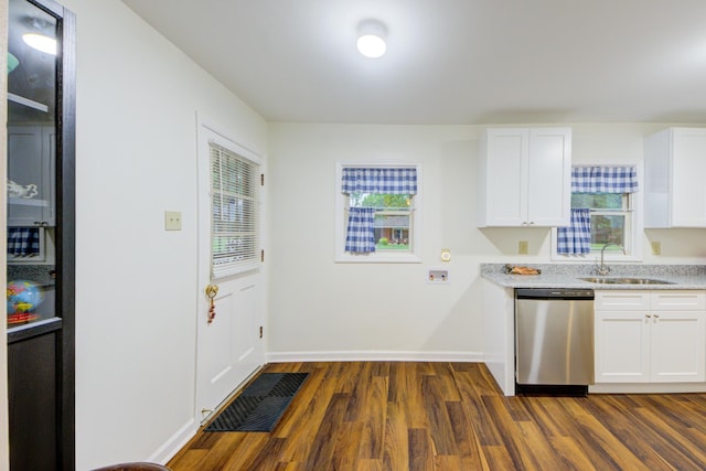 kitchen with dishwasher, light countertops, a sink, and white cabinets