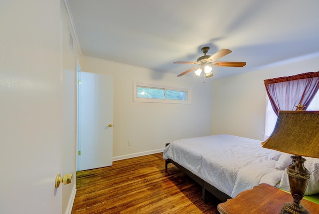 bedroom with ceiling fan, baseboards, and dark wood-style flooring