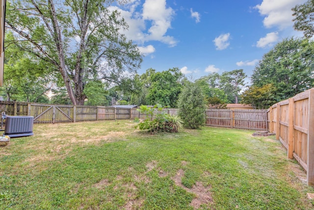 view of yard featuring a fenced backyard and central air condition unit