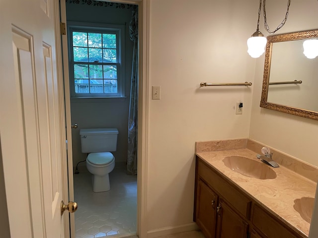 bathroom featuring tile flooring, large vanity, and toilet