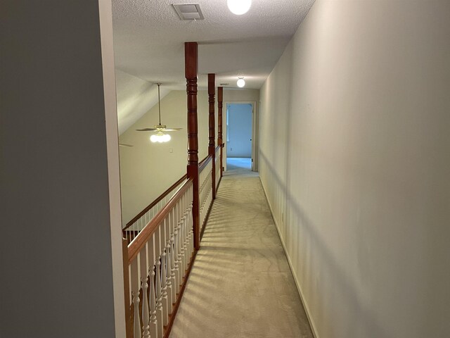 bonus room with carpet, ceiling fan, a textured ceiling, and lofted ceiling